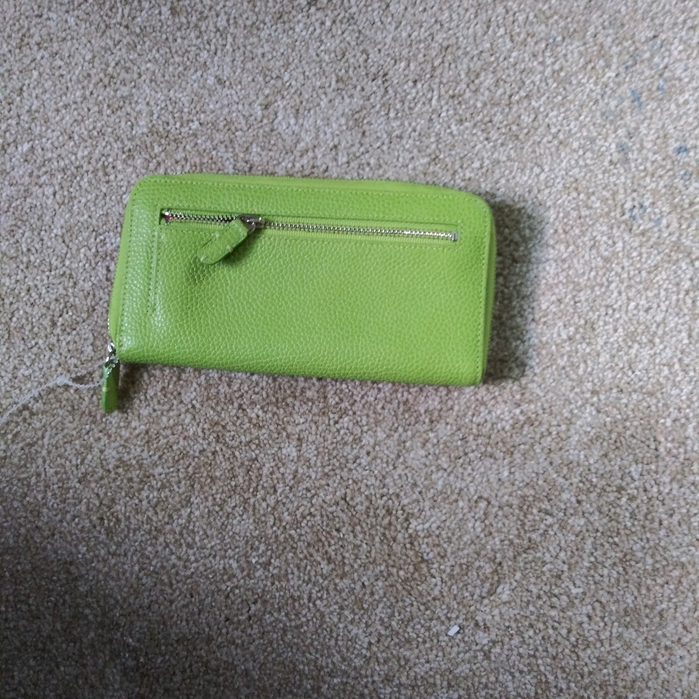 Tusk multi compartment leather wallet Measures 8 inch length  and 4.5 inches